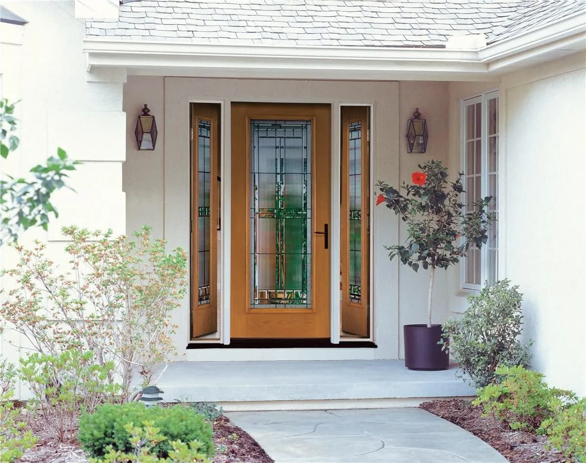 A traditional entry door with decorative glass and matching sidelights