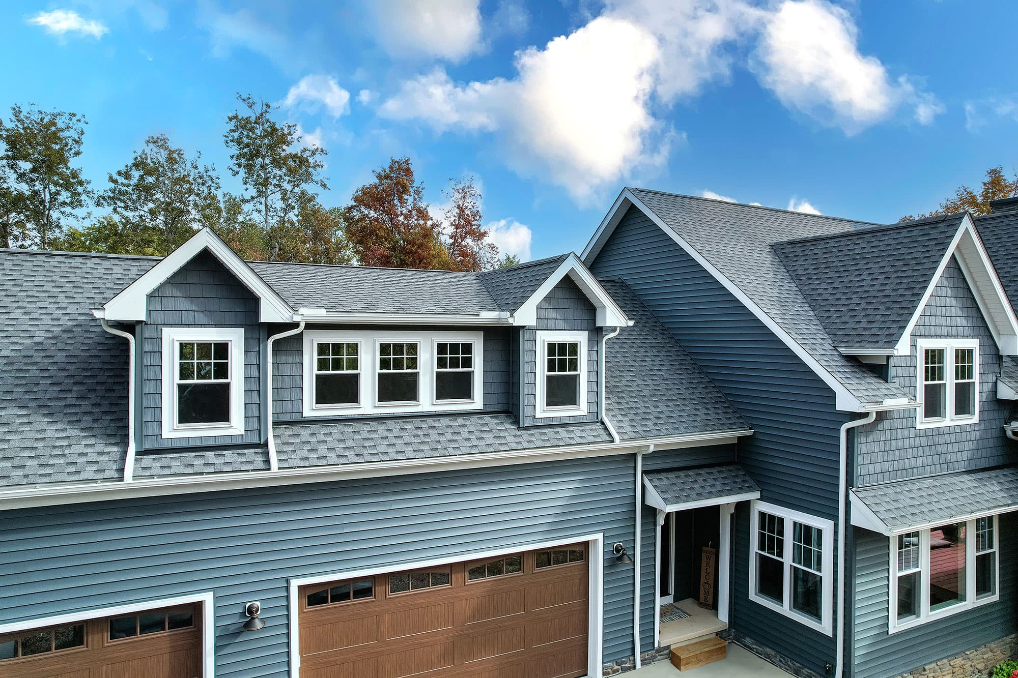 A house exterior with multiple gabled dormers and many double-hung windows