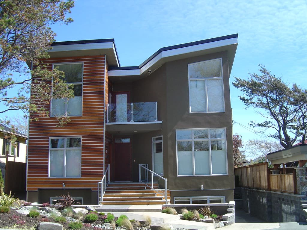 A house exterior with several windows of different sizes
